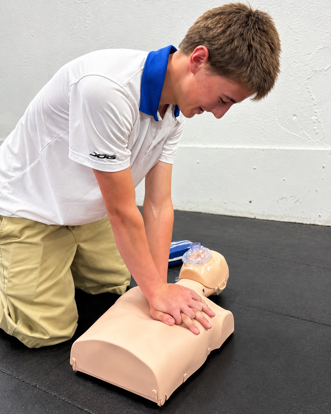 Participant practicing CPR chest compressions during an IFCRR lifesaving skills class.